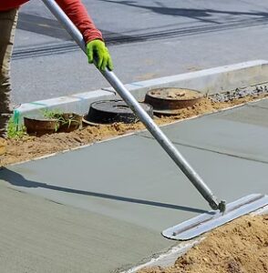 Laying down new sidewalk in wet concrete on freshly poured sidewalks_edited-1